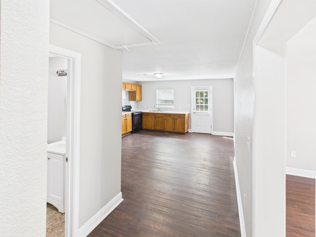 1325 S Main St, Vidor, TX 77662 - hallway featuring attic access, baseboards, a sink, and dark wood-style flooring