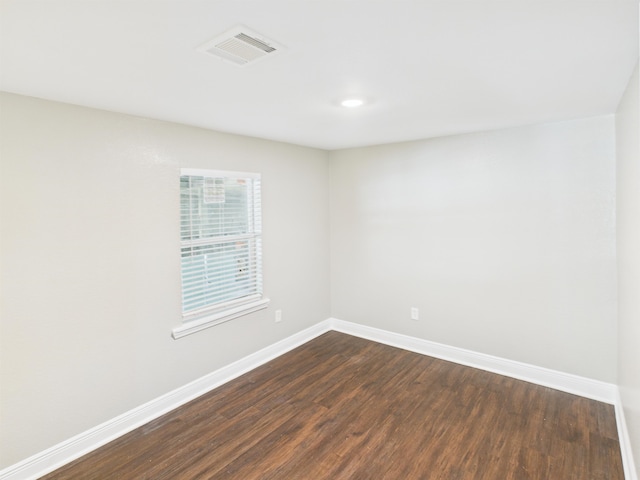 1325 S Main St, Vidor, TX 77662 - unfurnished room with baseboards, visible vents, and dark wood-style floors