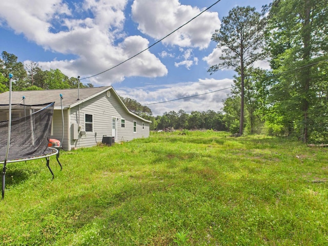 1325 S Main St, Vidor, TX 77662 - view of yard featuring central AC and a trampoline