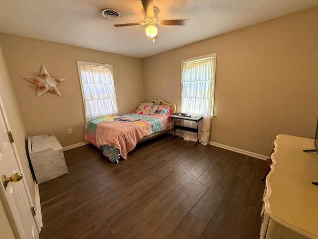 220 Dupuis St, Bridge City, TX 77611 - bedroom with dark wood finished floors, baseboards, and ceiling fan