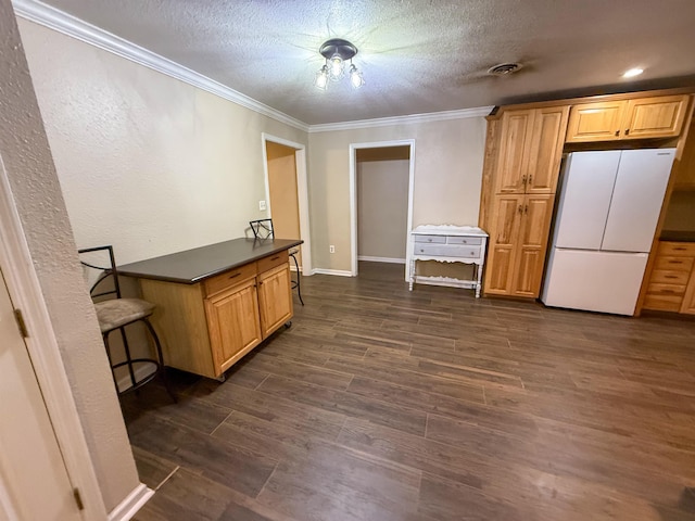 220 Dupuis St, Bridge City, TX 77611 - kitchen featuring freestanding refrigerator, dark countertops, ornamental molding, a textured ceiling, and dark wood-style floors