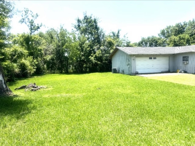 view of yard with a garage and cooling unit