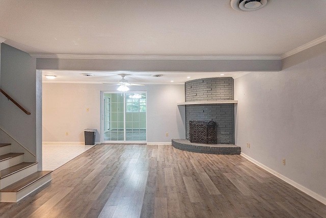 334 Pinehurst Dr, Sour Lake, TX 77659 - unfurnished living room featuring ornamental molding, wood finished floors, stairs, a ceiling fan, and baseboards