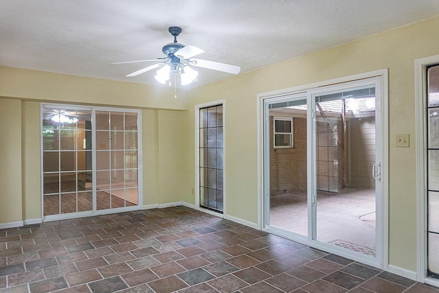 334 Pinehurst Dr, Sour Lake, TX 77659 - unfurnished room featuring ceiling fan, dark stone finish floors, and baseboards