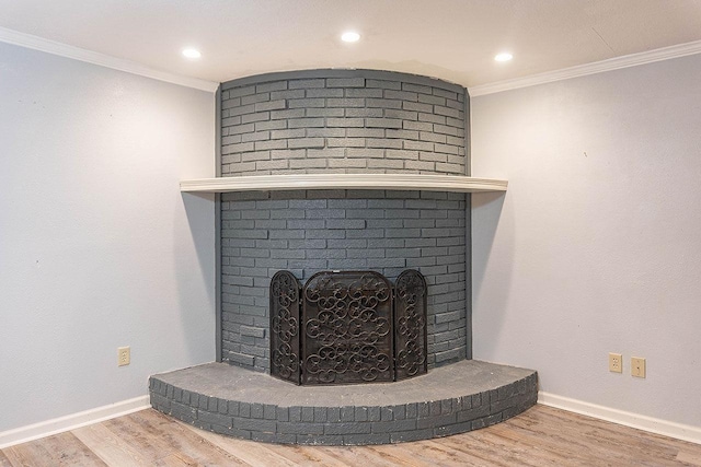334 Pinehurst Dr, Sour Lake, TX 77659 - detailed view of a brick fireplace, wood finished floors, ornamental molding, baseboards, and recessed lighting