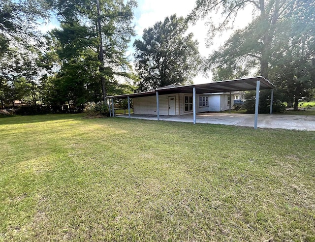 850 Orange St, Vidor, TX 77662 - view of green lawn with an attached carport