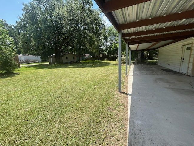 850 Orange St, Vidor, TX 77662 - view of grassy yard featuring a carport