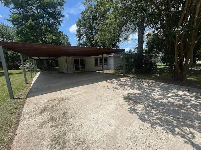 850 Orange St, Vidor, TX 77662 - view of front of home featuring driveway, an attached carport, and a front lawn