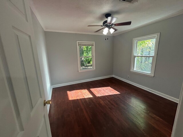 850 Orange St, Vidor, TX 77662 - empty room with healthy amount of natural light, crown molding, dark wood-type flooring, and a ceiling fan