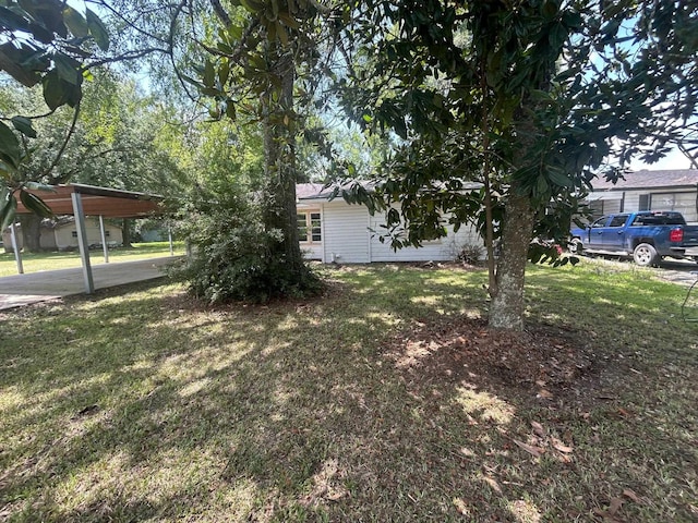 850 Orange St, Vidor, TX 77662 - view of green lawn featuring a detached carport