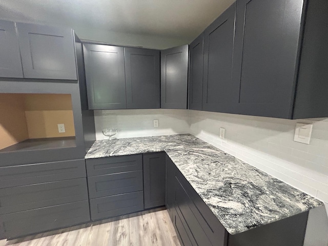 850 Orange St, Vidor, TX 77662 - kitchen featuring light stone countertops, gray cabinets, and light wood-style floors