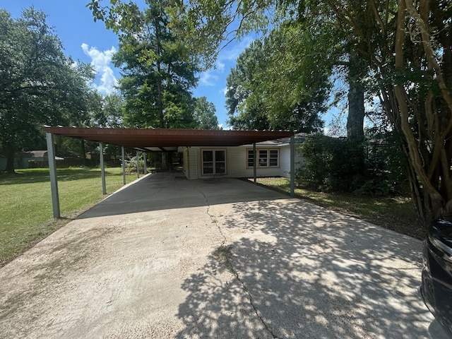 850 Orange St, Vidor, TX 77662 - view of front of home featuring a front yard, concrete driveway, and a carport