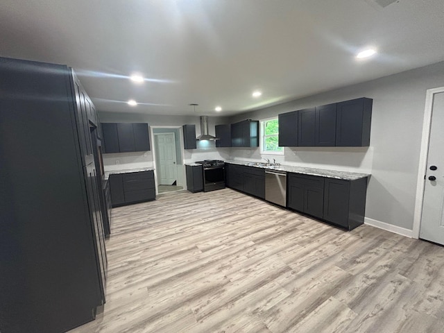 850 Orange St, Vidor, TX 77662 - kitchen featuring stainless steel appliances, wall chimney exhaust hood, light wood-style floors, light countertops, and recessed lighting