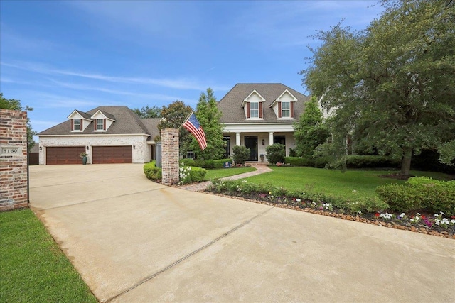 5160 Littlechase Dr, Beaumont, TX 77706 - view of front of home featuring driveway, a front yard, a garage, and covered porch