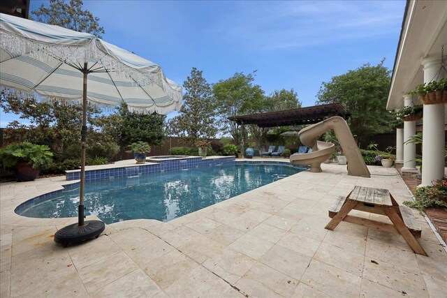 5160 Littlechase Dr, Beaumont, TX 77706 - view of swimming pool with a water slide, a patio area, a fenced backyard, and a pool with connected hot tub