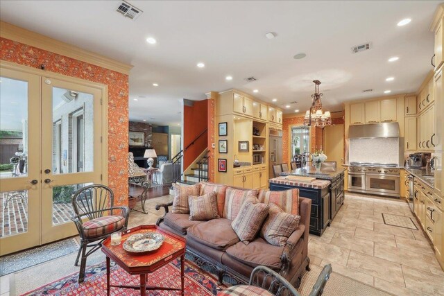 5160 Littlechase Dr, Beaumont, TX 77706 - living room with french doors, stairway, a chandelier, recessed lighting, and light stone finish flooring