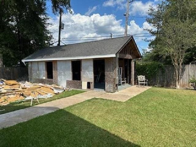 view of outdoor structure featuring a lawn