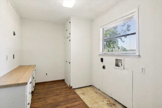 clothes washing area featuring hardwood / wood-style floors, cabinets, ornamental molding, and hookup for a washing machine