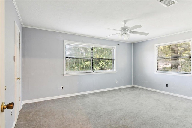 unfurnished room featuring carpet, a wealth of natural light, and crown molding