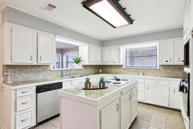 kitchen with dishwasher, a center island, white cabinetry, and sink