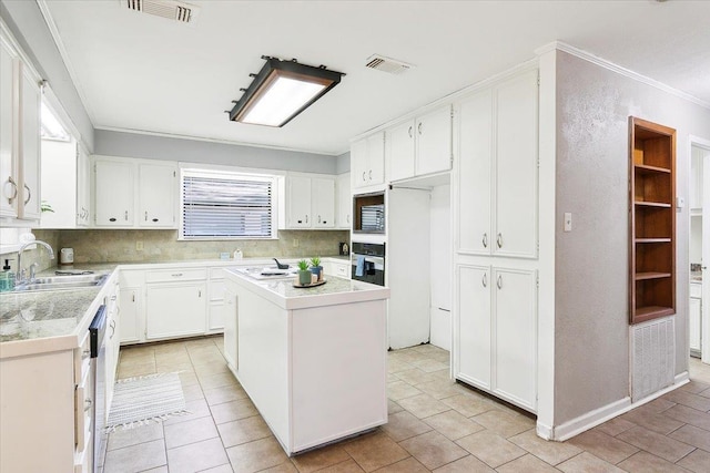 kitchen featuring oven, a kitchen island, white cabinetry, and sink