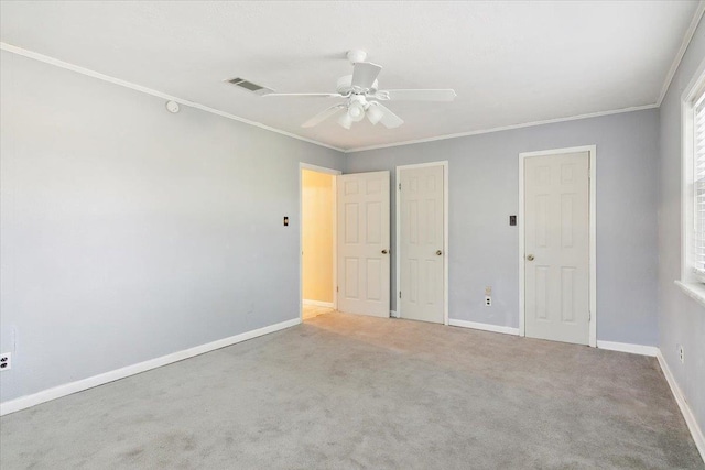 unfurnished bedroom featuring light carpet, ceiling fan, and crown molding