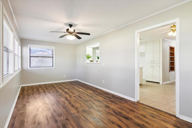 spare room with ceiling fan, ornamental molding, and dark wood-type flooring