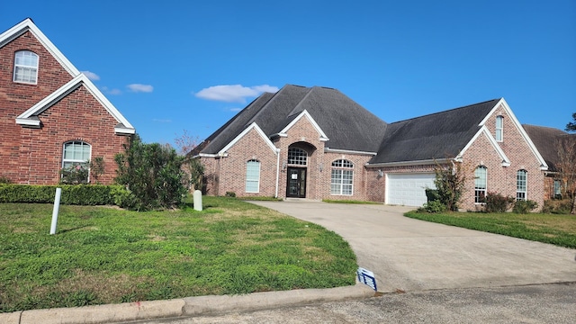 view of property featuring a garage and a front yard