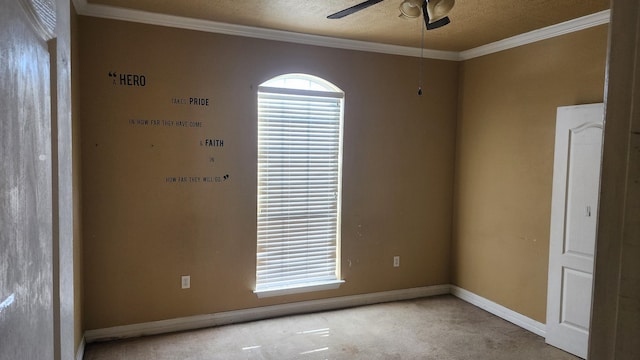 empty room with ceiling fan and ornamental molding