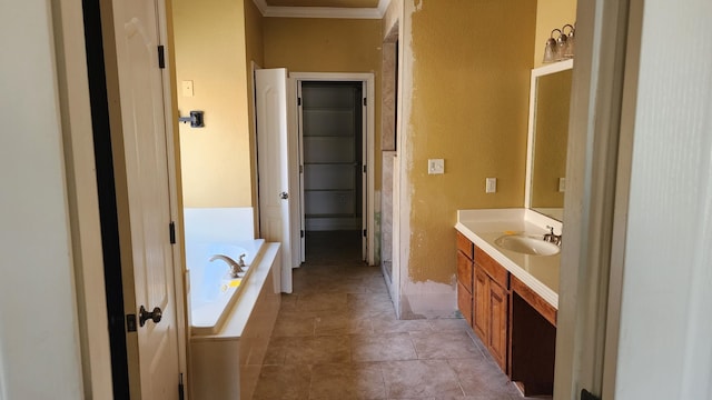 bathroom featuring crown molding, a tub to relax in, and vanity