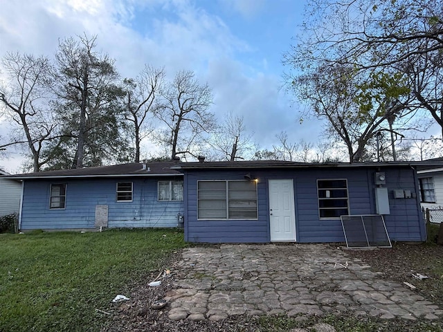 back of house with a yard and a patio area