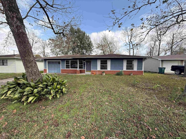 single story home with a front yard and a garage