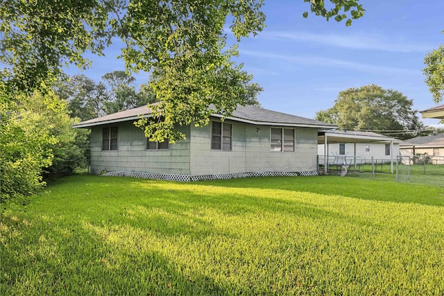 view of side of property with a yard