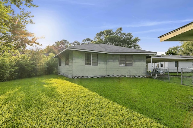 view of side of property with a yard and a carport