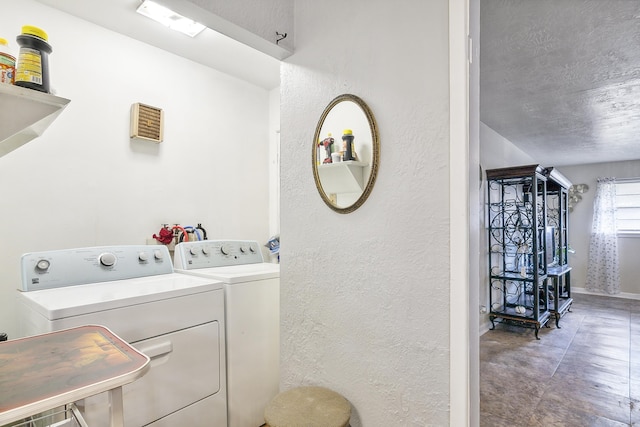 washroom with sink, washer and dryer, and a textured ceiling