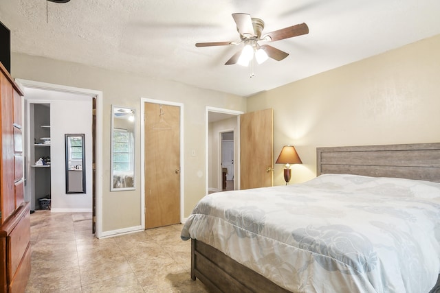 bedroom featuring ceiling fan and a textured ceiling