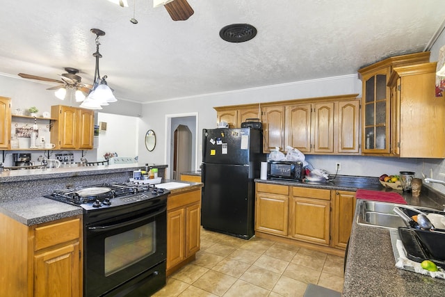 kitchen featuring a textured ceiling, ceiling fan, black appliances, pendant lighting, and light tile patterned flooring