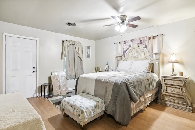 bedroom with hardwood / wood-style floors and ceiling fan