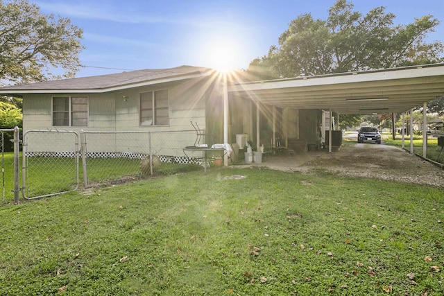 exterior space with a lawn, cooling unit, and a carport