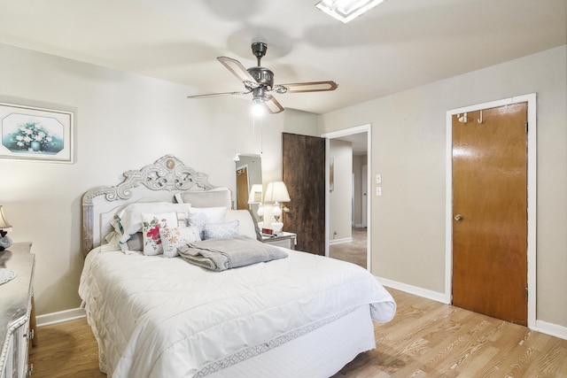 bedroom featuring light hardwood / wood-style floors and ceiling fan