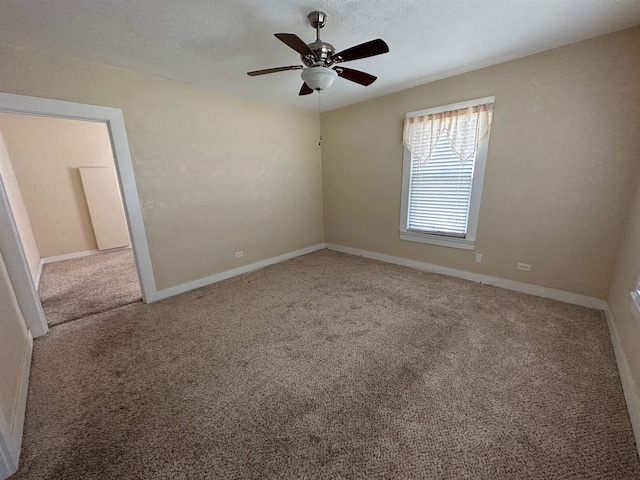 unfurnished room with carpet flooring, ceiling fan, and a textured ceiling