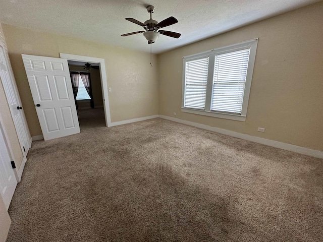 spare room featuring a textured ceiling and carpet floors