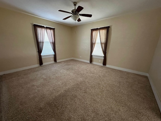 empty room featuring carpet, ceiling fan, and a healthy amount of sunlight