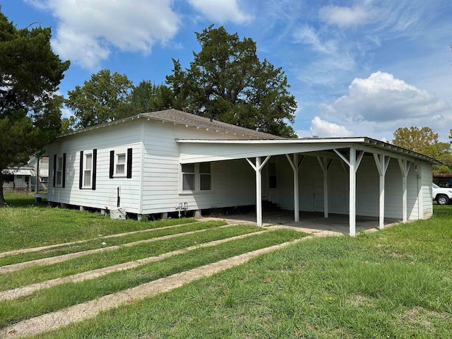 exterior space with a front yard and a carport