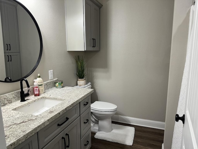 bathroom featuring hardwood / wood-style floors, vanity, and toilet