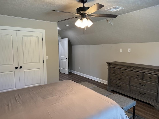 bedroom with ceiling fan, a closet, dark wood-type flooring, and lofted ceiling