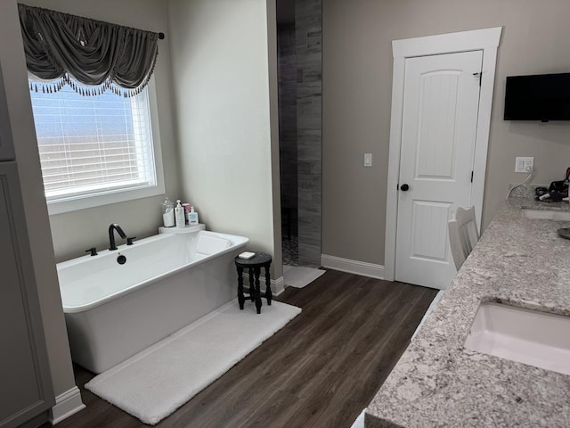 bathroom with separate shower and tub, vanity, and wood-type flooring