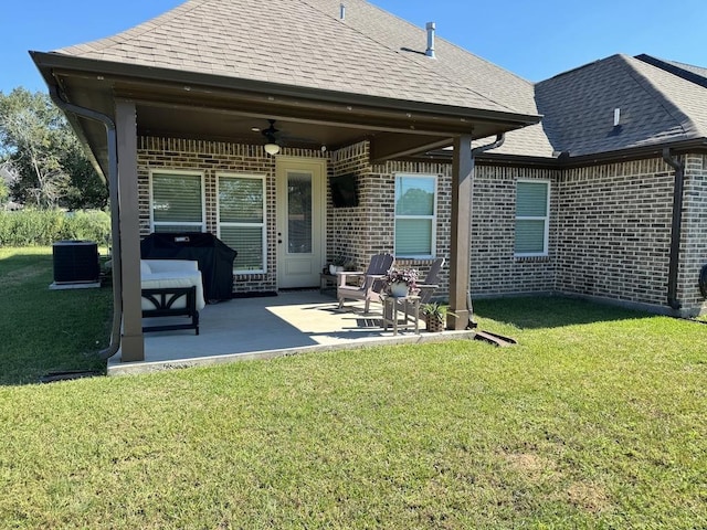 back of house with ceiling fan, a yard, a patio, and central AC unit