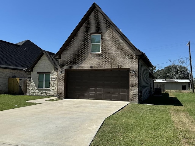 view of front of home featuring a garage and a front lawn