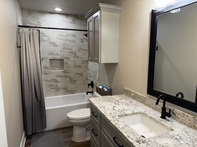 full bathroom featuring vanity, wood-type flooring, shower / tub combo, and toilet